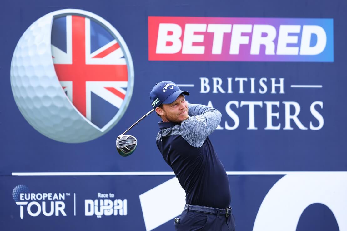 Danny Willett schlägt vor dem Plakat des Betfred British Masters ab