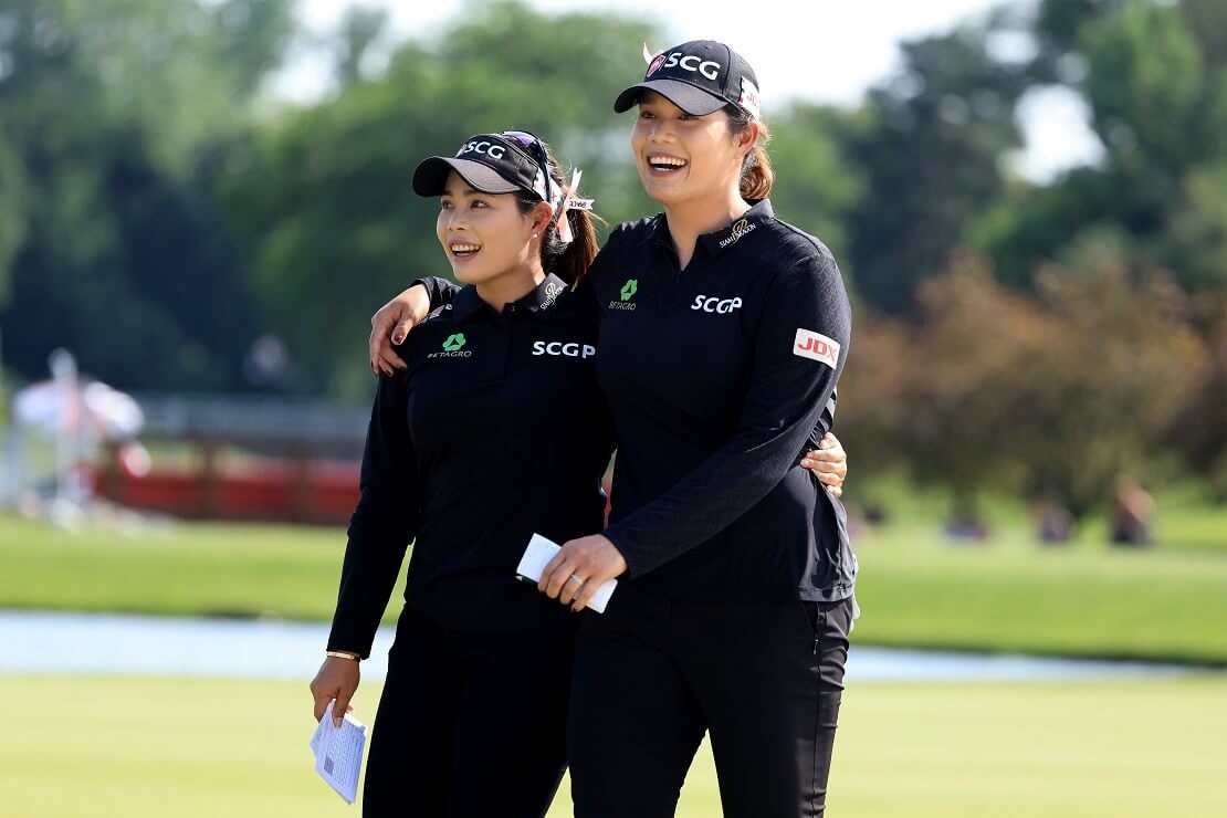 Ariya und Moriya Jutanugarn laufen Arm in Arm über den Platz