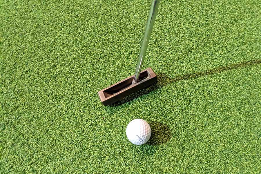 Ein Golfball und ein Golfschläger namens Putter