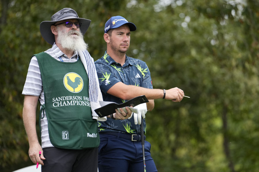 Golfer Lucas Herbert neben einem Caddie mit weißem Rauschebart