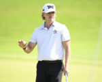 Golfer Jake Knapp hält einen Golfball in der einen Hand und einen Schläger in der anderen