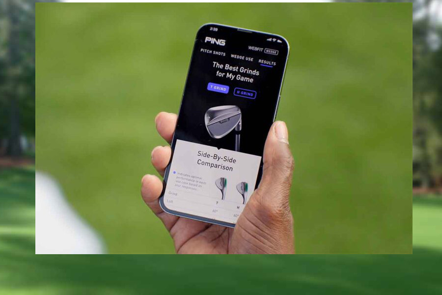 Eine Hand hält ein Handy, auf dem Screen sieht man eine Golf-App