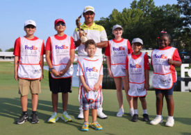 Hideki Matsuyama, umringt von einigen Kindern mit der Trophäe für den Gewinn der FedEx St. Jude Championship 2024